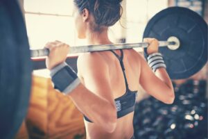 6 strength training benefits everyone should know about woman wotking out with barbell